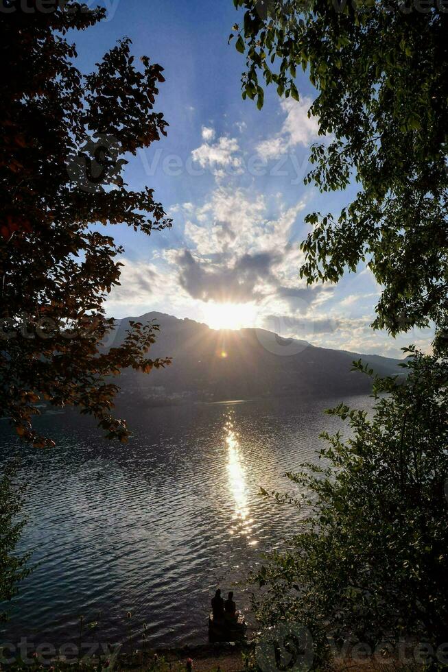 il sole è ambientazione al di sopra di un' lago foto