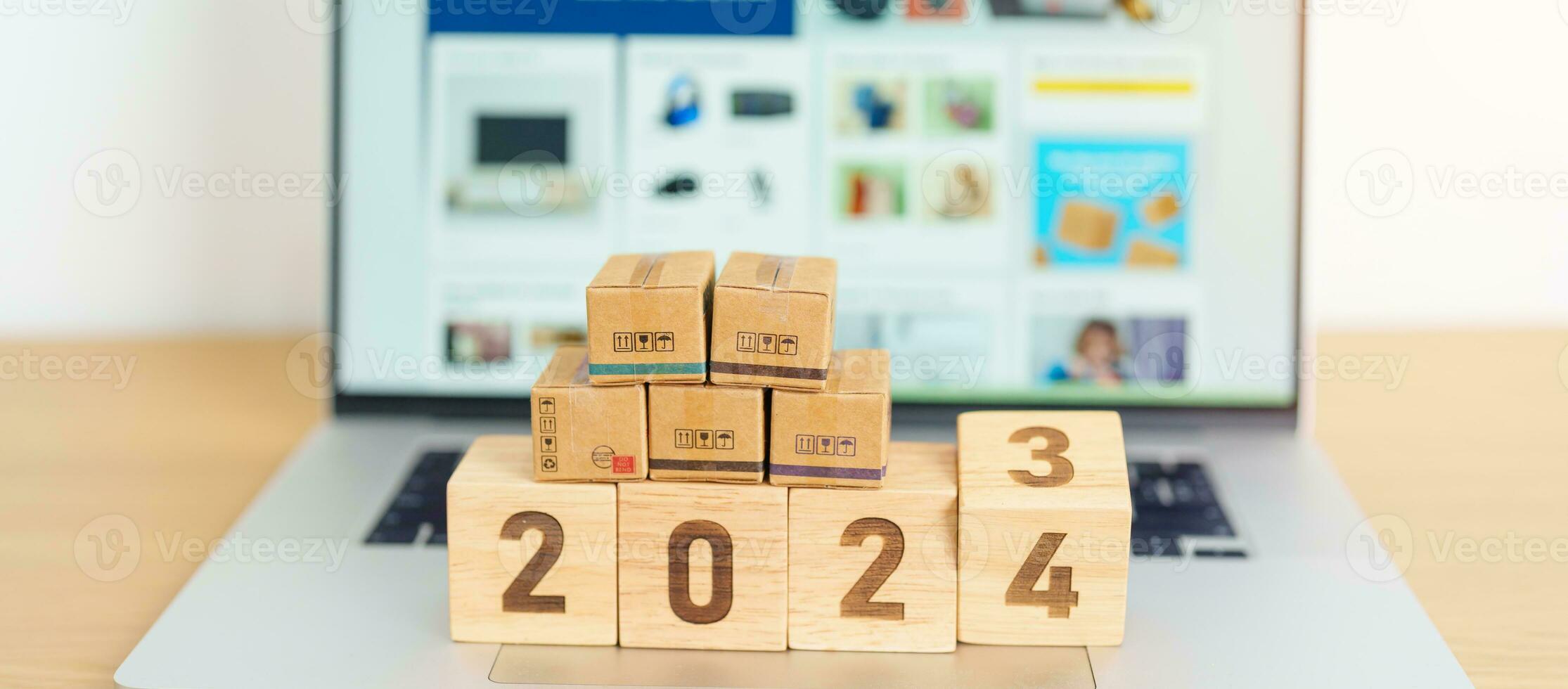 2024 nuovo anno in linea shopping concetto. spedizione scatole su il computer portatile computer. vendita e sconto durante Natale e nuovo anno vacanza, commercio elettronico, spedizione consegna, la logistica e informatica Lunedi foto