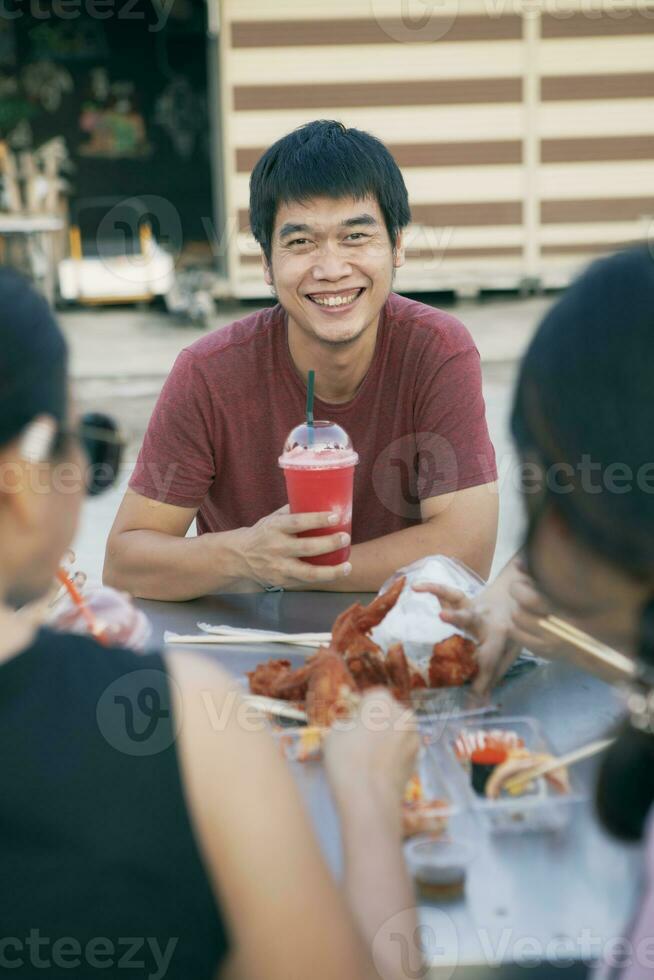 asiatico uomo sorridente con felicità desiderio freddo bevanda bottiglia nel mano foto