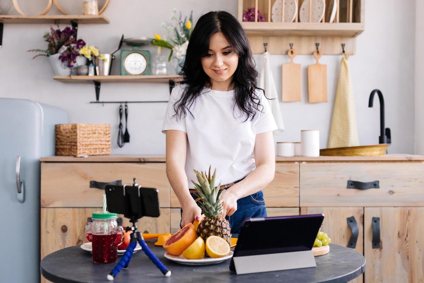 bella ragazza prepara cibo sano e delizioso e gira video per il suo blog foto