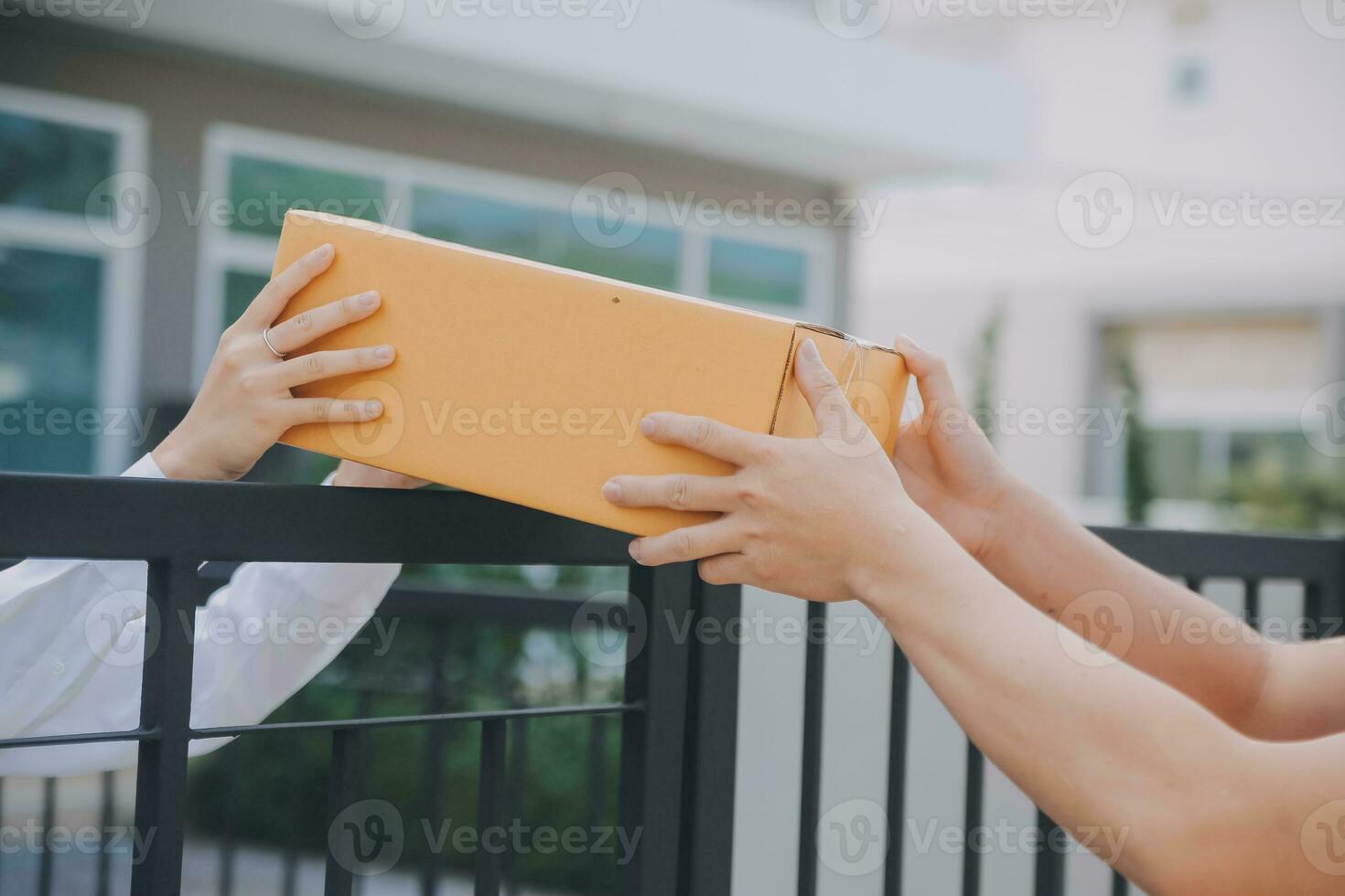 asiatico donna ricevente Prodotto a partire dal consegna uomo a casa, giovane proprietario donna ordine Prodotto a partire dal smartphone applicazione, donna con in linea attività commerciale o pmi concetto. foto