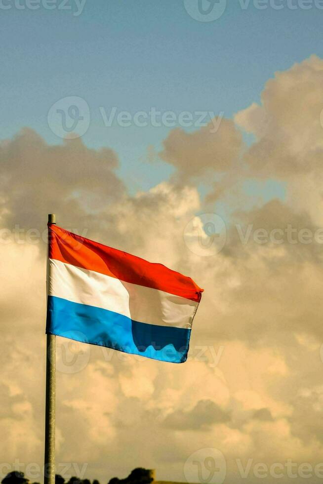 il Olanda bandiera volante nel il vento foto