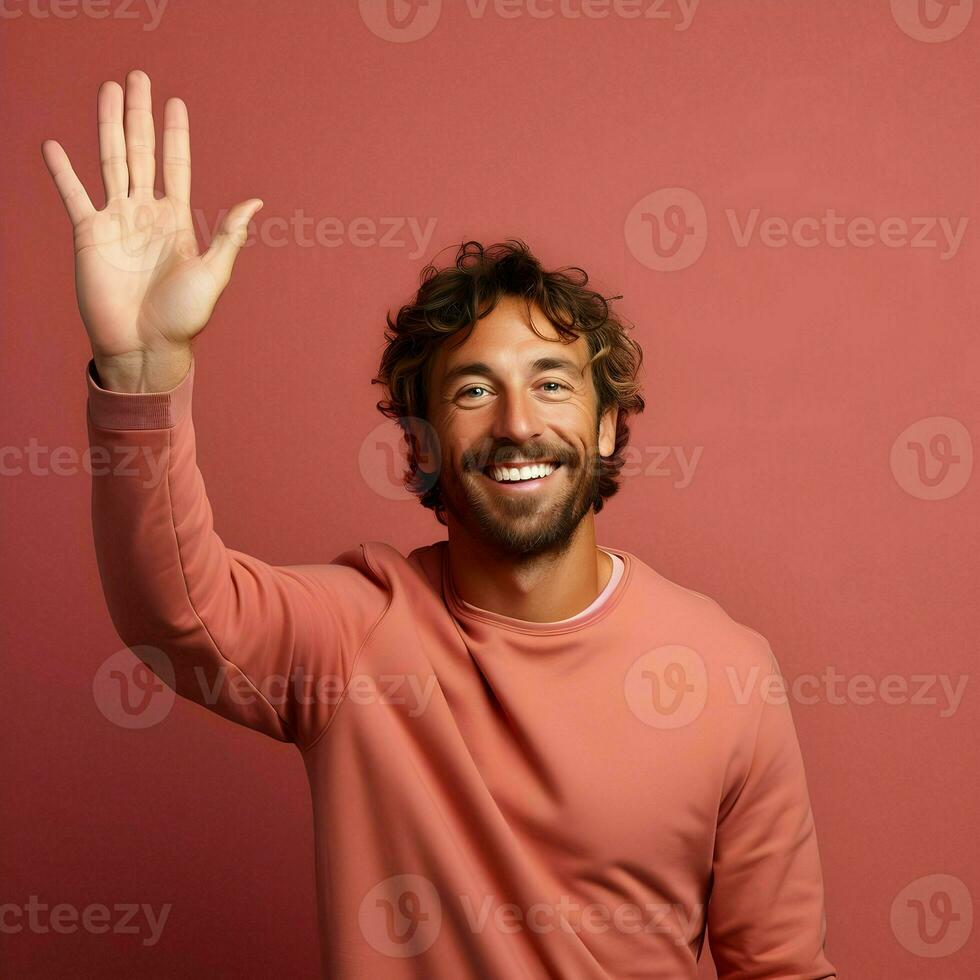 ai generato foto di il sorridente uomo agitando il suo mano su un' rosa sfondo. alto qualità. ai generativo