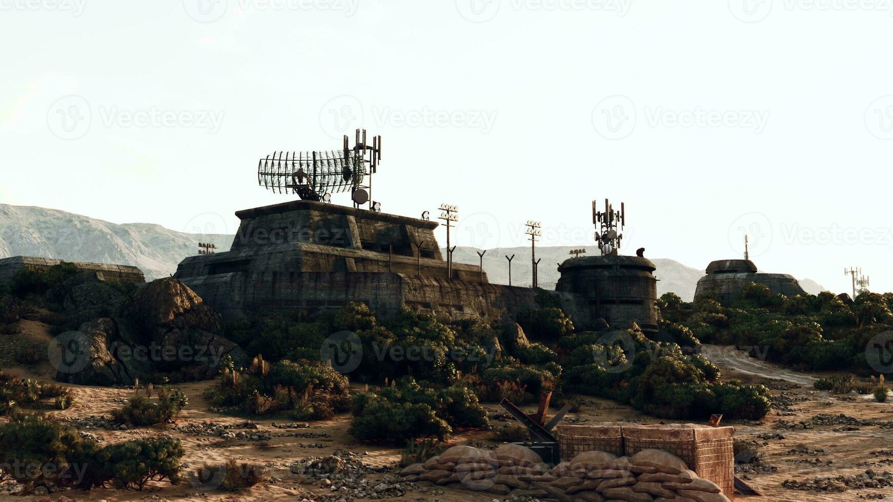 un' deserto paesaggio con rocce e alberi circostante un' militare base guerra bunker foto