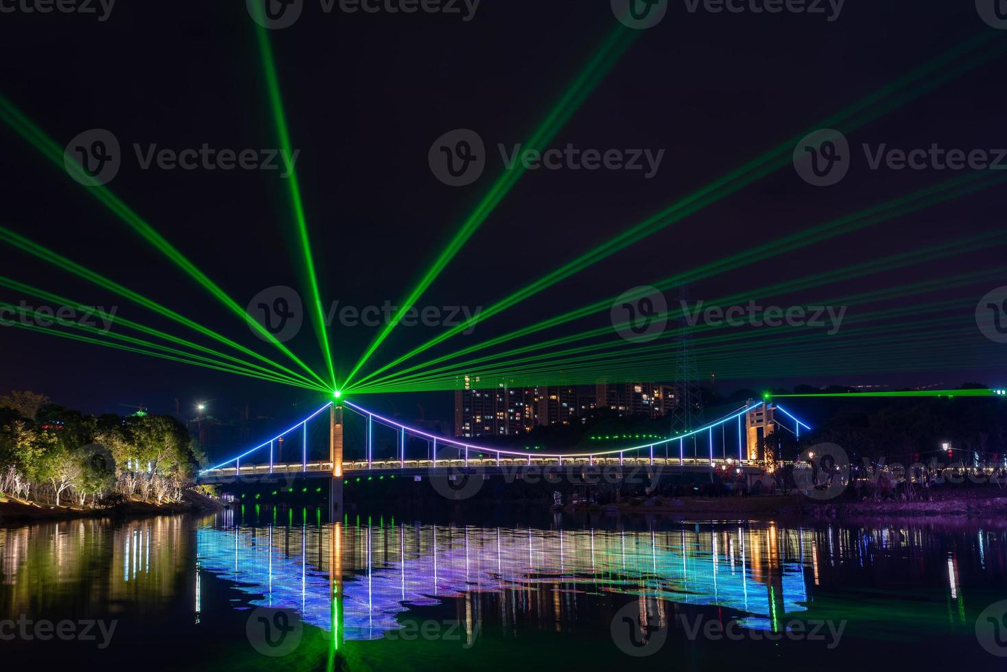 di notte, il ruscello riflette le luci colorate sul ponte foto