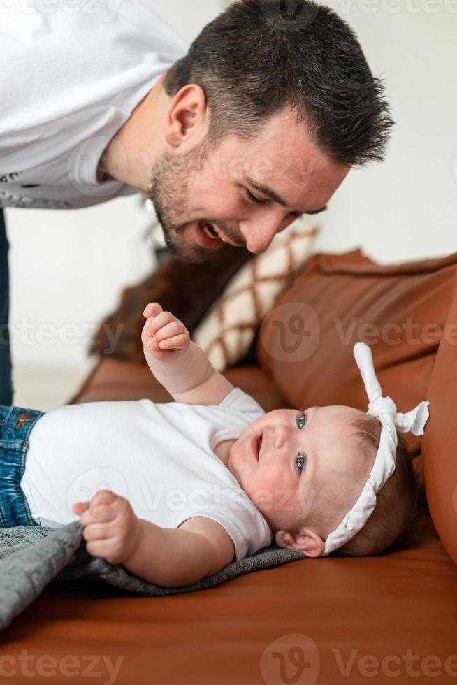 bella ragazza sdraiata su di lei che guarda amorevolmente suo padre attraente foto