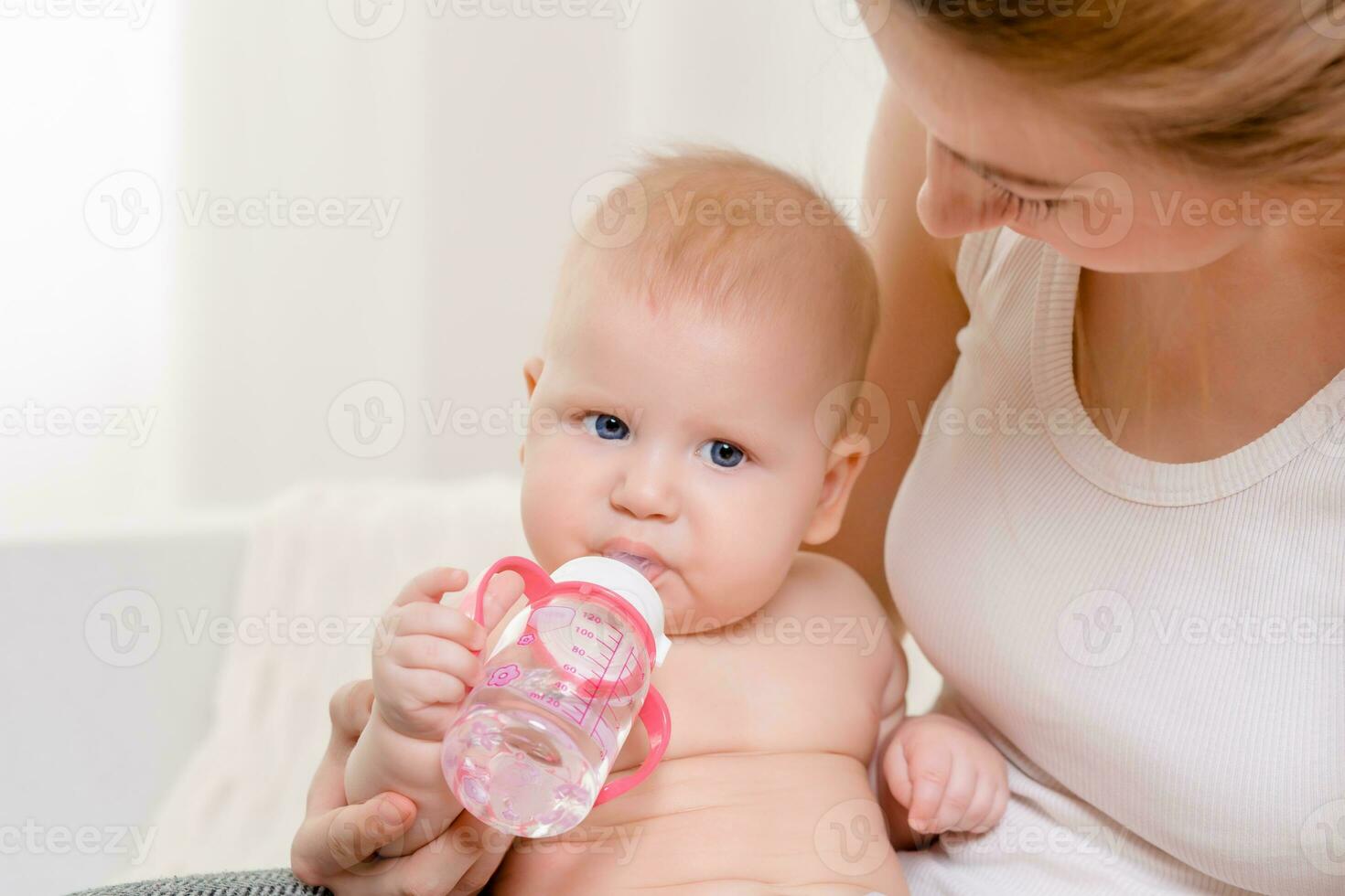 alimentazione bambino. bambino mangiare latte a partire dal il bottiglia. foto