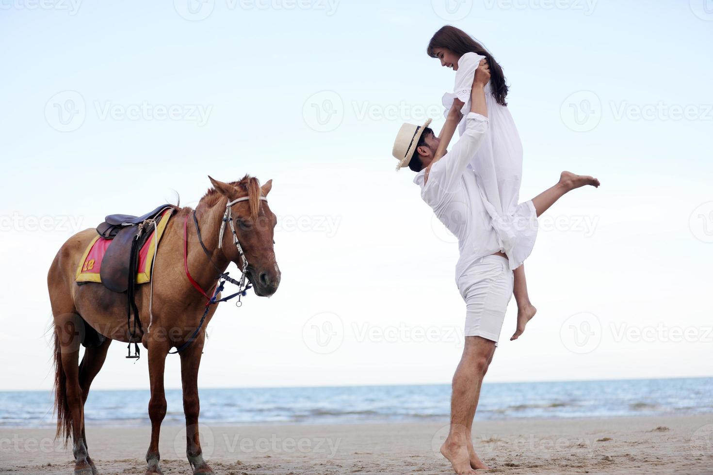 felice coppie romantiche amante che si tengono per mano insieme camminando sulla spiaggia foto