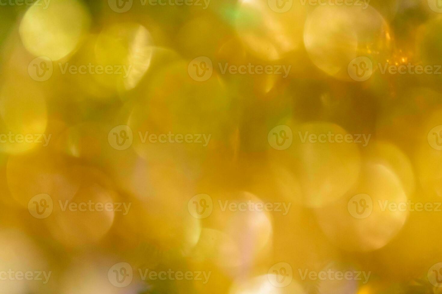 d'oro bokeh luci vicino su come sfondo. luminosa il giro d'oro giallo Natale luci come sfondo foto