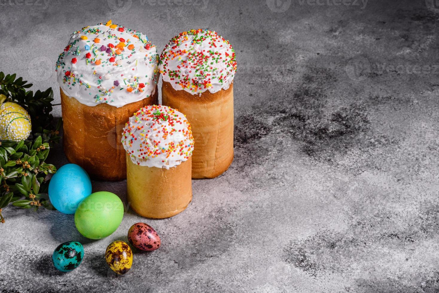 torta di pasqua e uova colorate su sfondo scuro foto