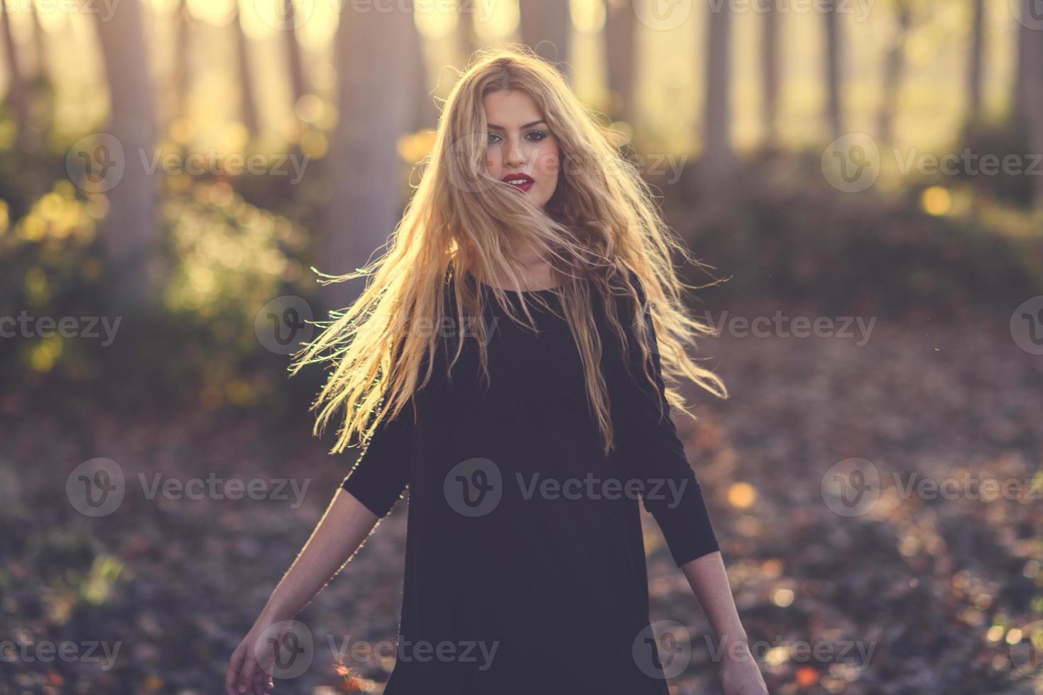 giovane donna bionda che balla nella foresta di pioppi foto