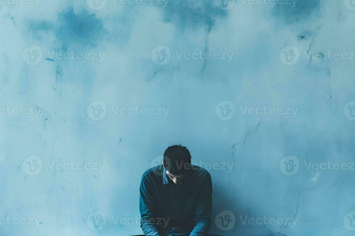ai generato triste depresso stanco uomo seduta su blu sfondo blu Lunedi concetto mentale Salute disturbo copia spazio foto