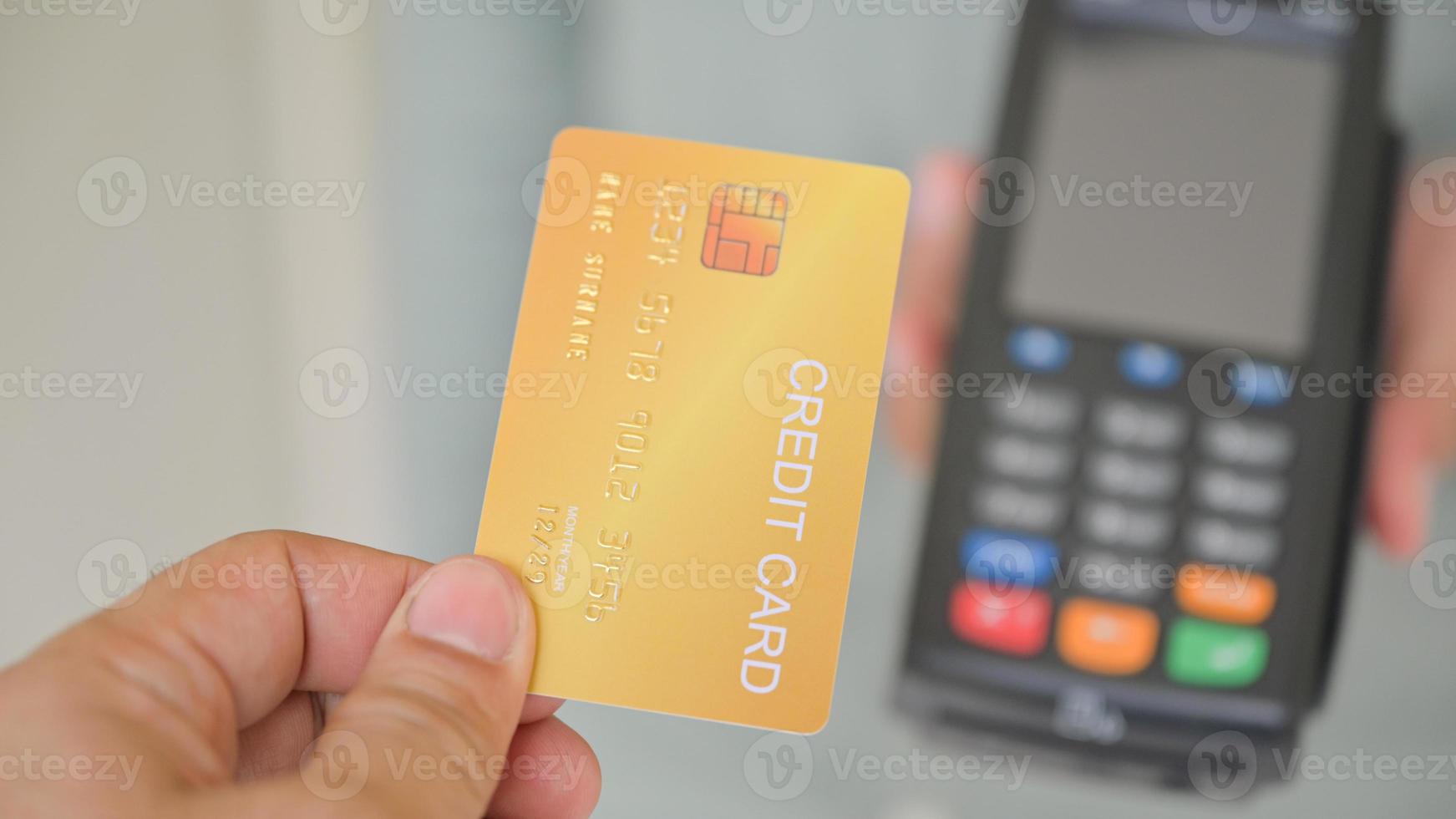 primo piano di clienti che pagano con carta di credito tramite edc. foto