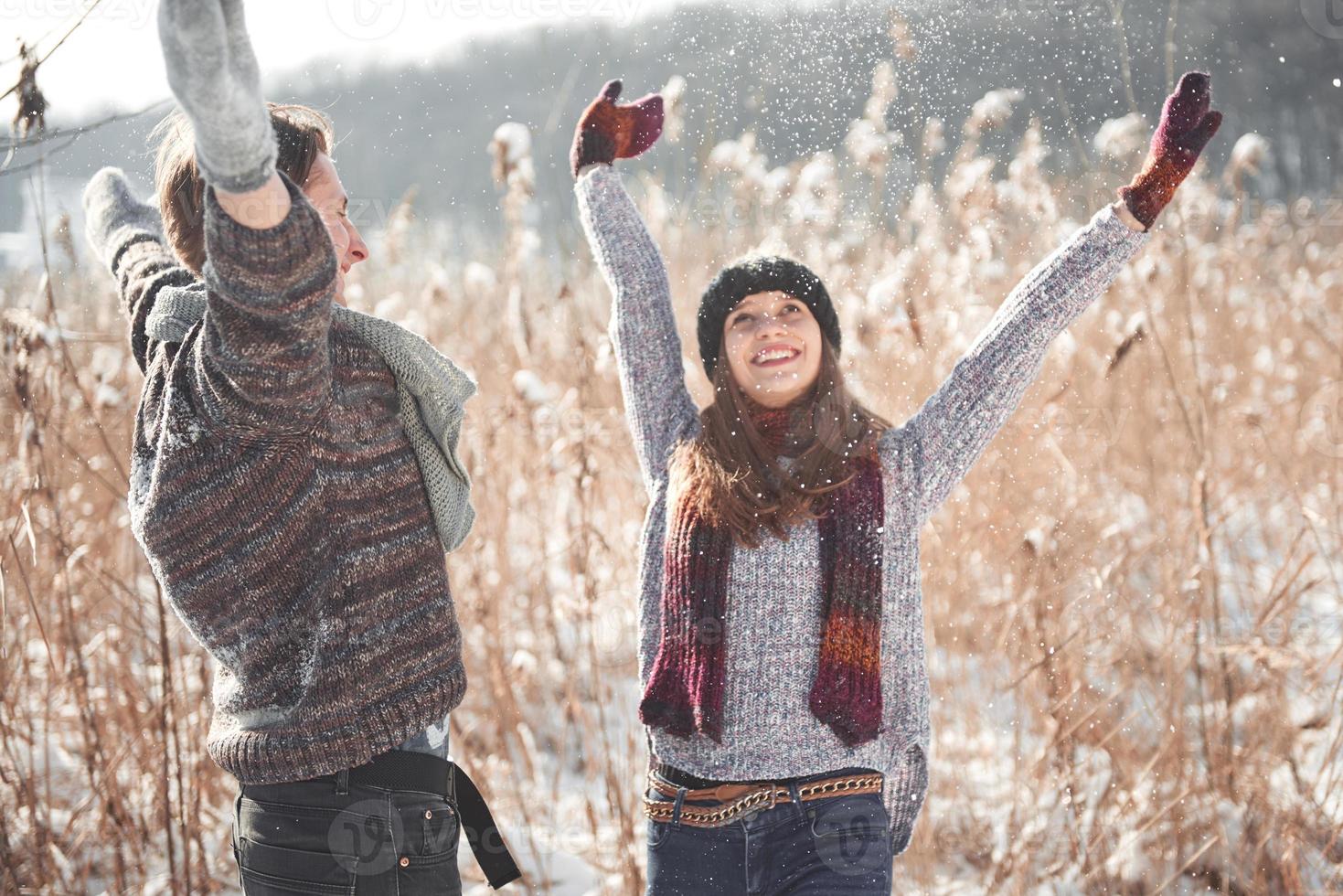 concetto di persone, stagione, amore e tempo libero - coppia felice che si diverte su sfondo invernale foto