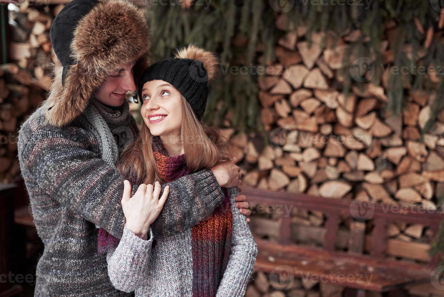 natale coppia felice innamorata abbraccio in inverno nevoso foresta fredda, copia spazio, celebrazione festa di capodanno, vacanze e vacanze, viaggi, amore e relazioni foto