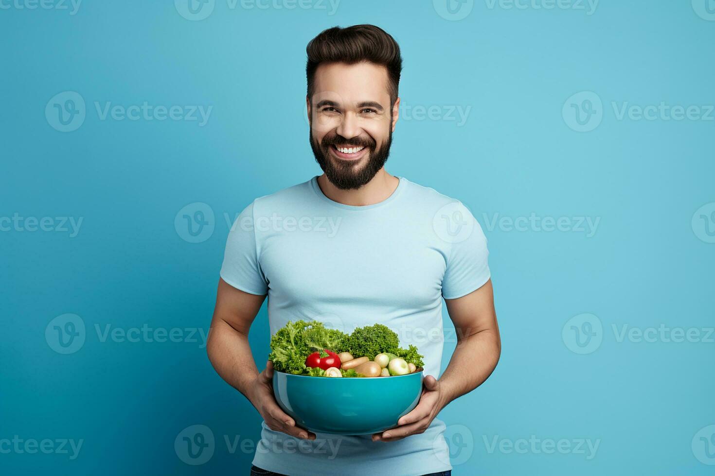 ai generato contento giovane vegetariano in posa a blu parete con bicchiere ciotola di fresco biologico verdure foto