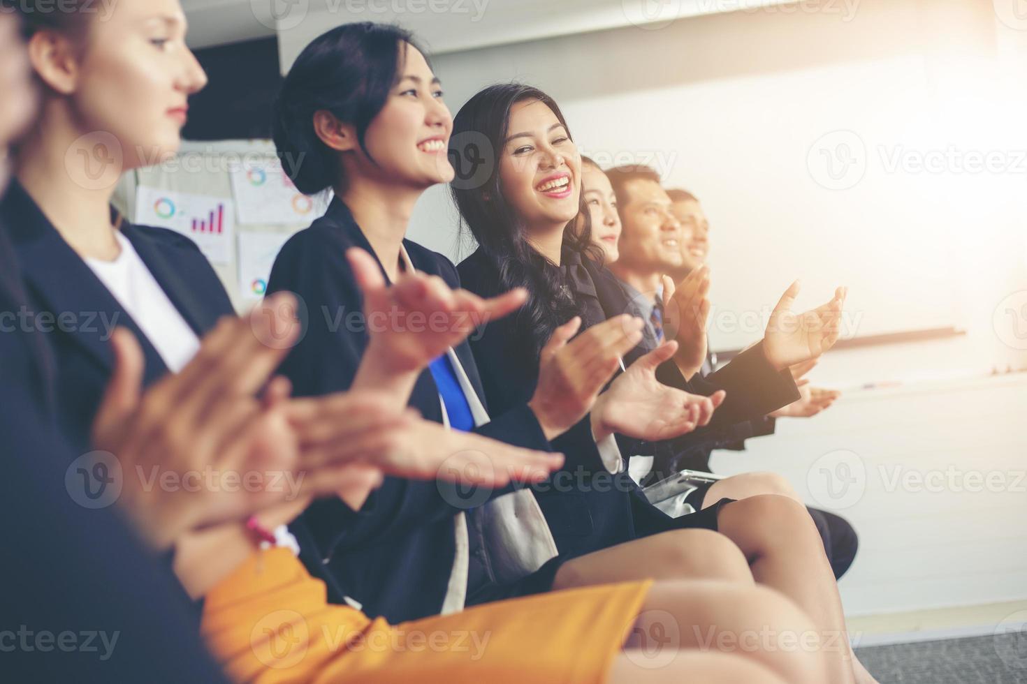 dirigenti aziendali che applaudono in una riunione d'affari foto