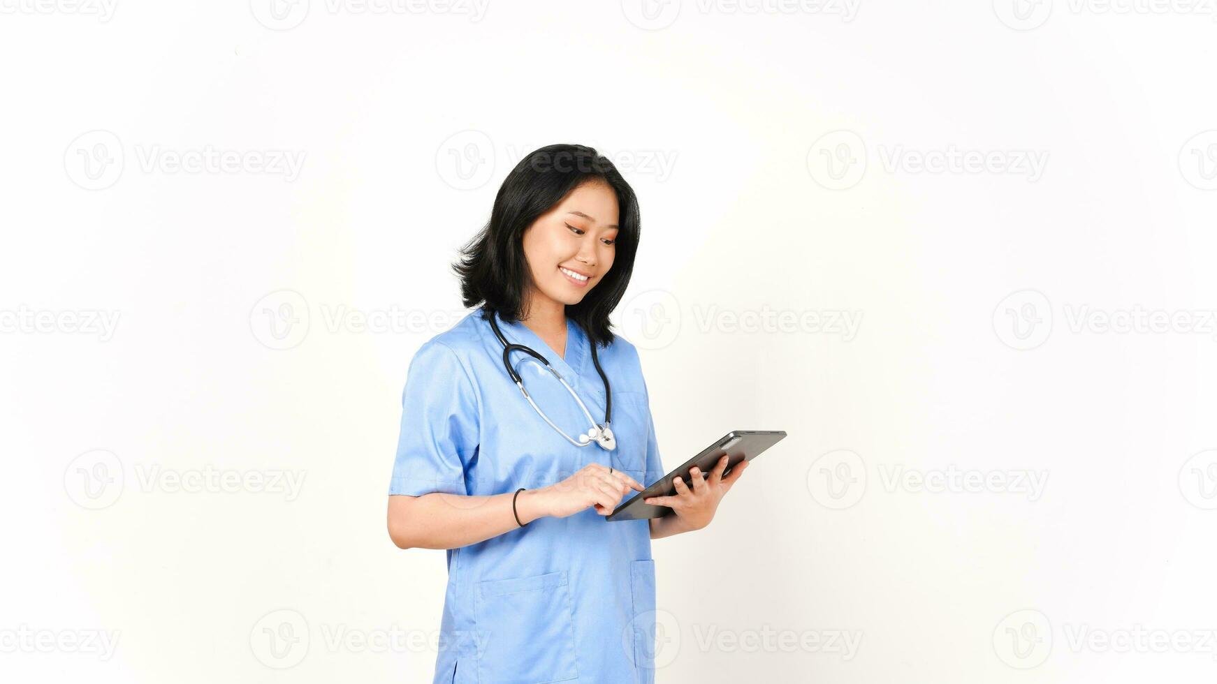 giovane asiatico femmina medico utilizzando tavoletta per opera e sorridente isolato su bianca sfondo foto