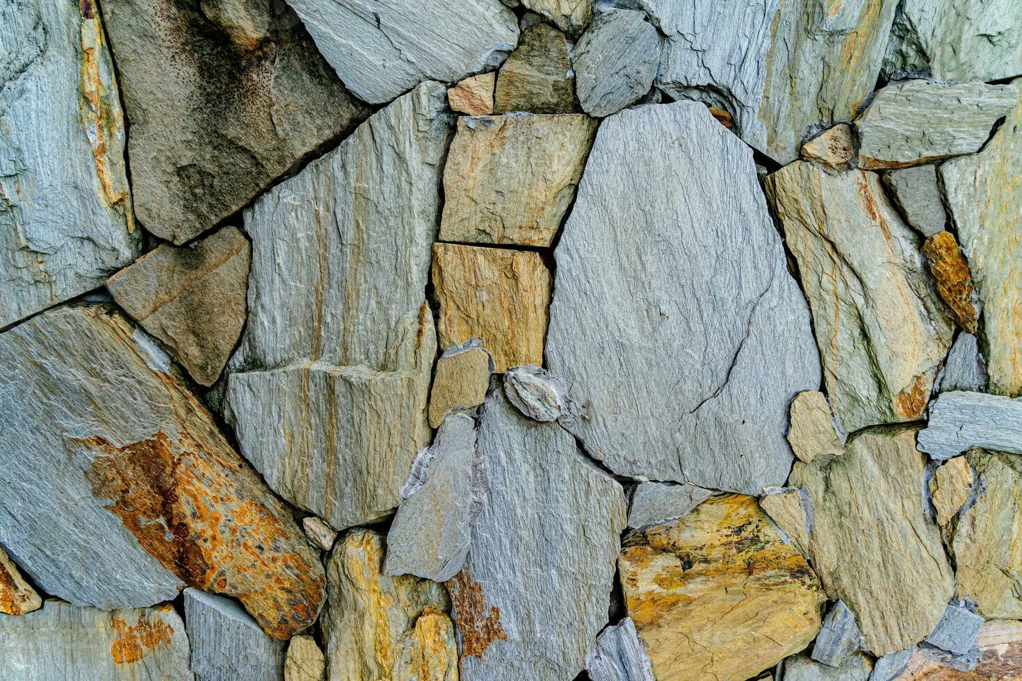 struttura di un muro di pietra. fondo di struttura del muro di pietra del vecchio castello. muro di pietra come sfondo o texture. parte di un muro di pietra, per sfondo o texture foto