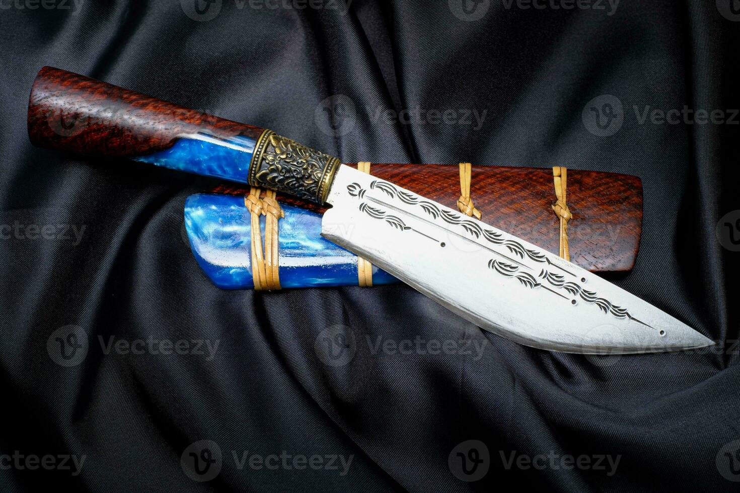 coltello personalizzato o enep nel fodero in legno naturale sul vecchio sfondo del tavolo fatto a mano in thailandia foto