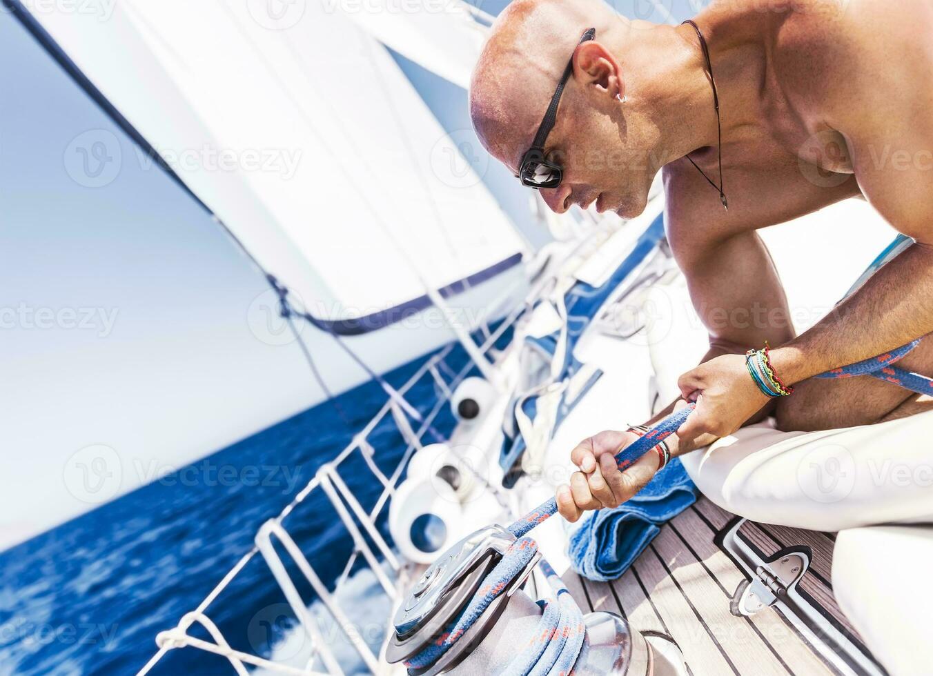 bello uomo su barca a vela foto