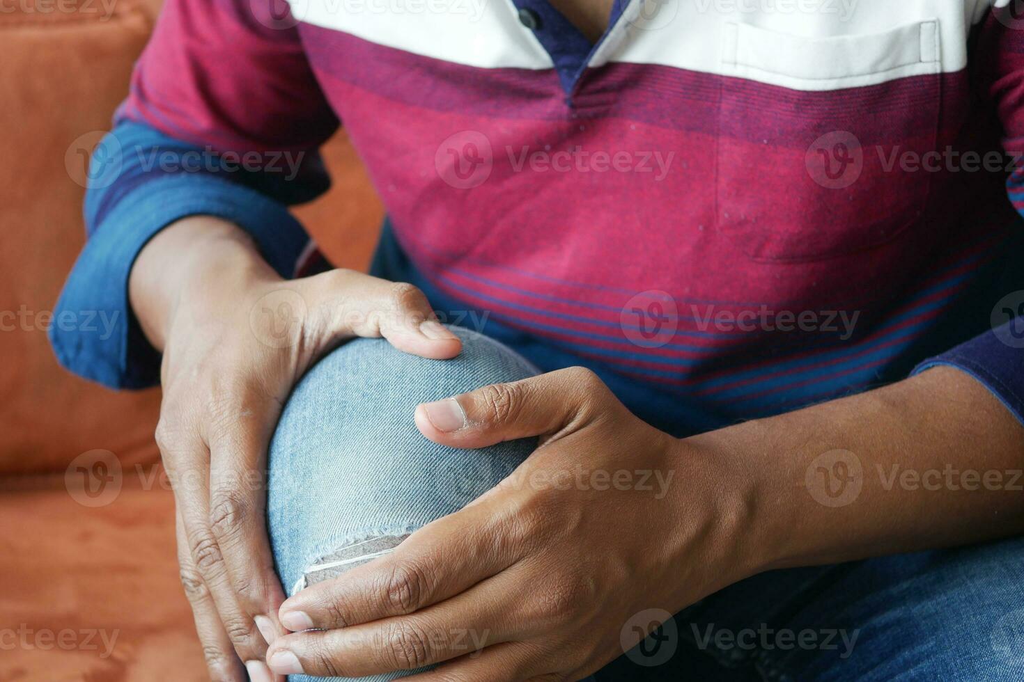 primo piano su un uomo che soffre di dolore all'articolazione del ginocchio foto