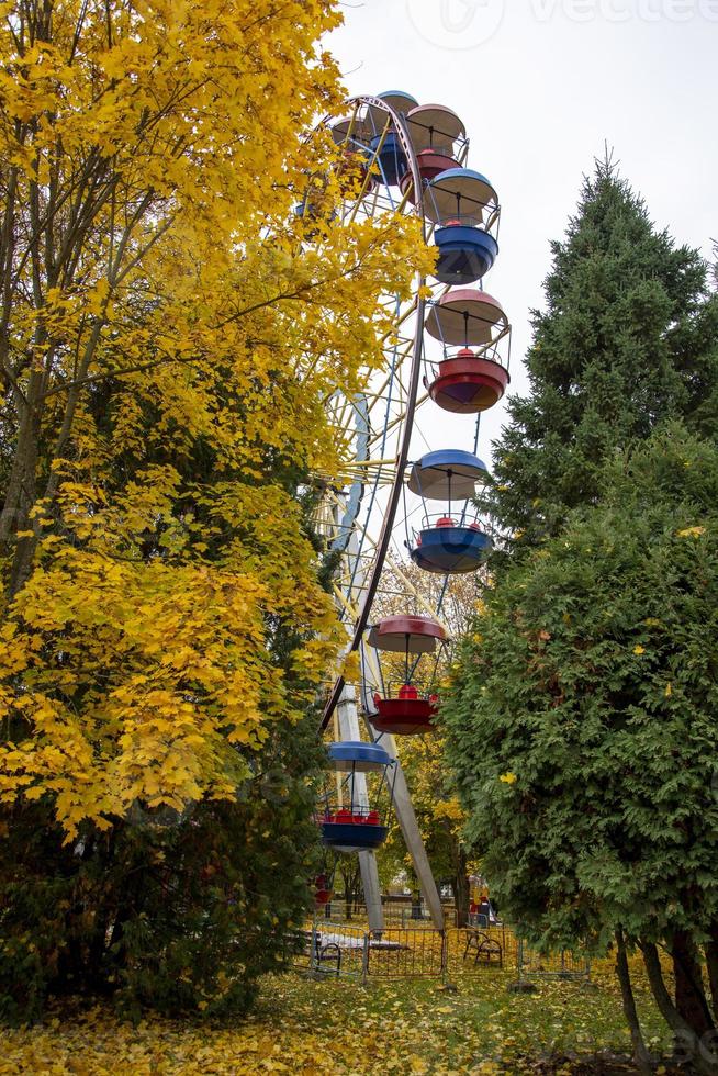 parcheggiare in autunno. ruota panoramica in un parco cittadino in una giornata autunnale. foto