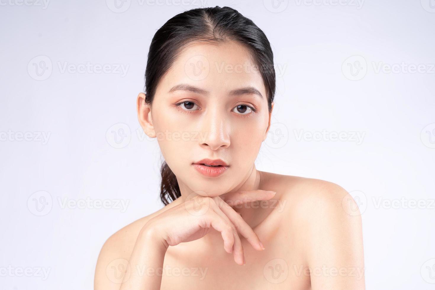 attraente giovane donna asiatica con pelle giovanile. cura del viso, trattamento del viso, pelle di bellezza della donna isolata su fondo bianco. cosmetologia, bellezza della pelle e concetto cosmetico foto