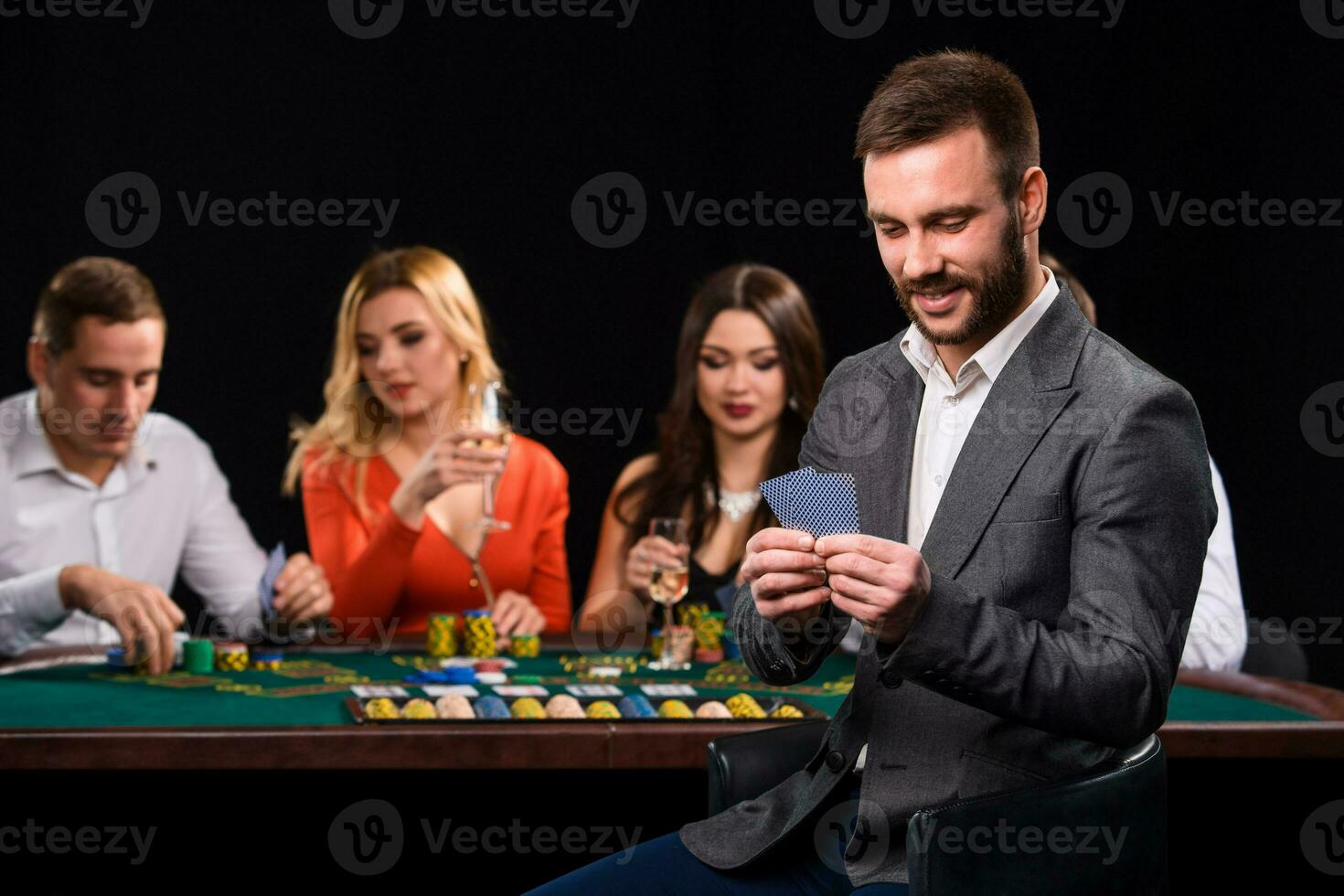 poker Giocatori nel casinò con carte e patatine fritte su nero sfondo foto