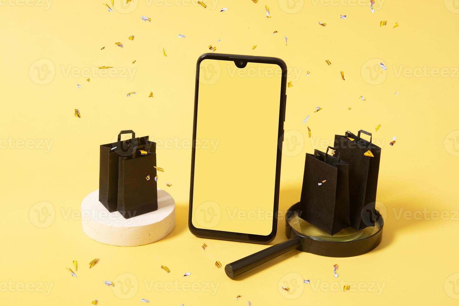 mockup di telefono e borse nere in passerella con lo shopping nella vendita del venerdì nero con scintillii foto