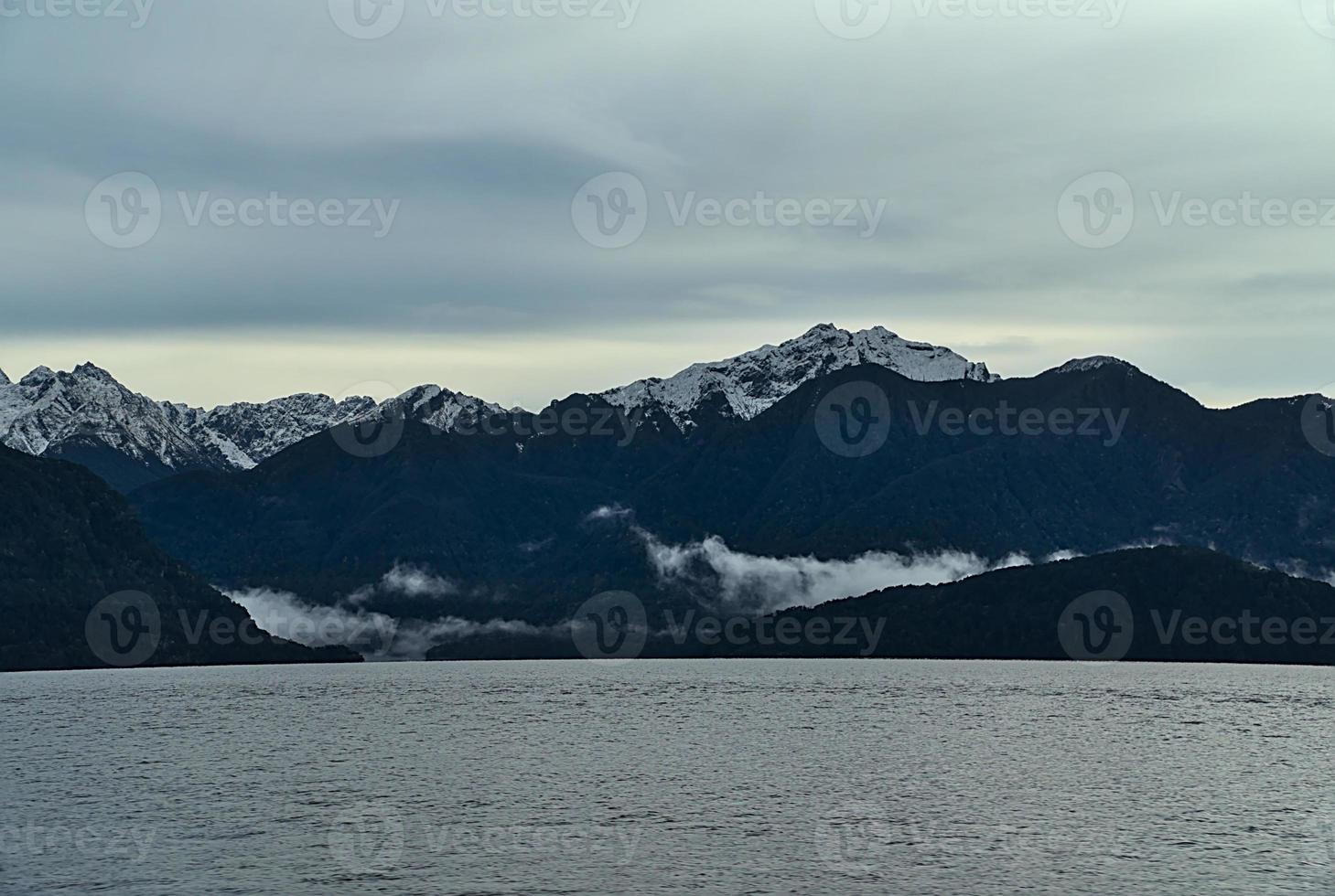 montagne innevate in riva al lago foto