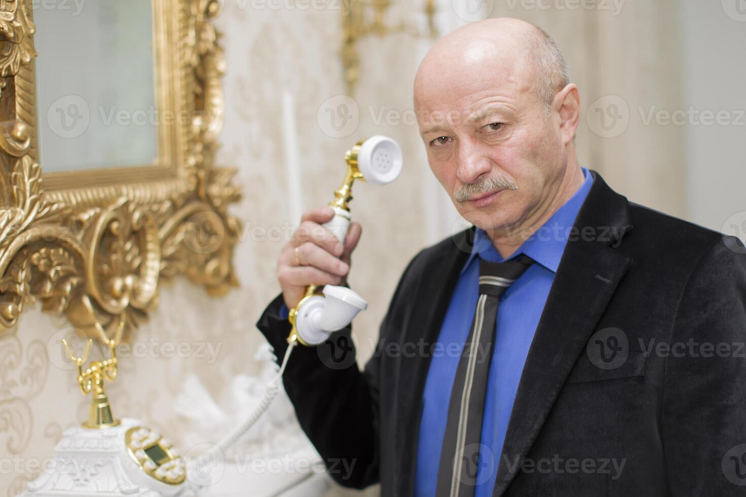 stravagante anziano uomo con un' retrò Telefono foto