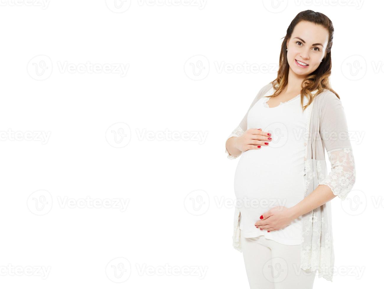 giovane felice bella donna incinta in posa isolato su bianco. foto