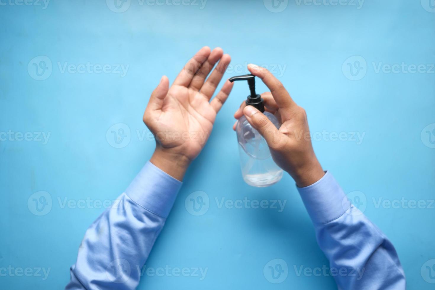 utilizzando un liquido disinfettante per prevenire il virus corona foto