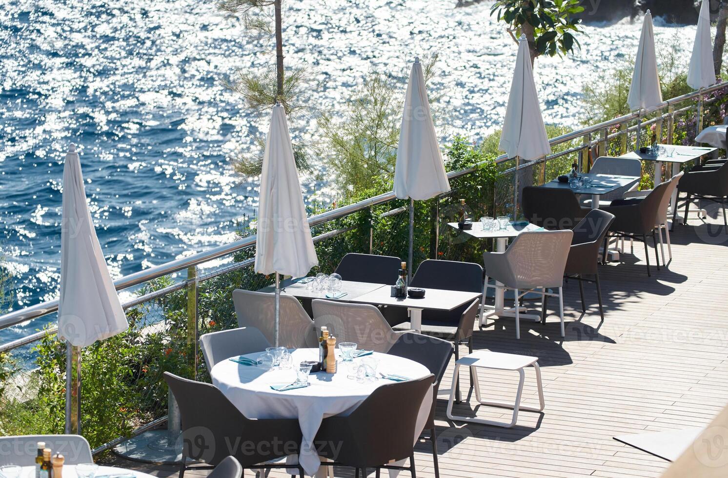 il vuoto bar su argine su il molo nel il porta di monaco, acqua riflessi su il sfondo a soleggiato giorno foto