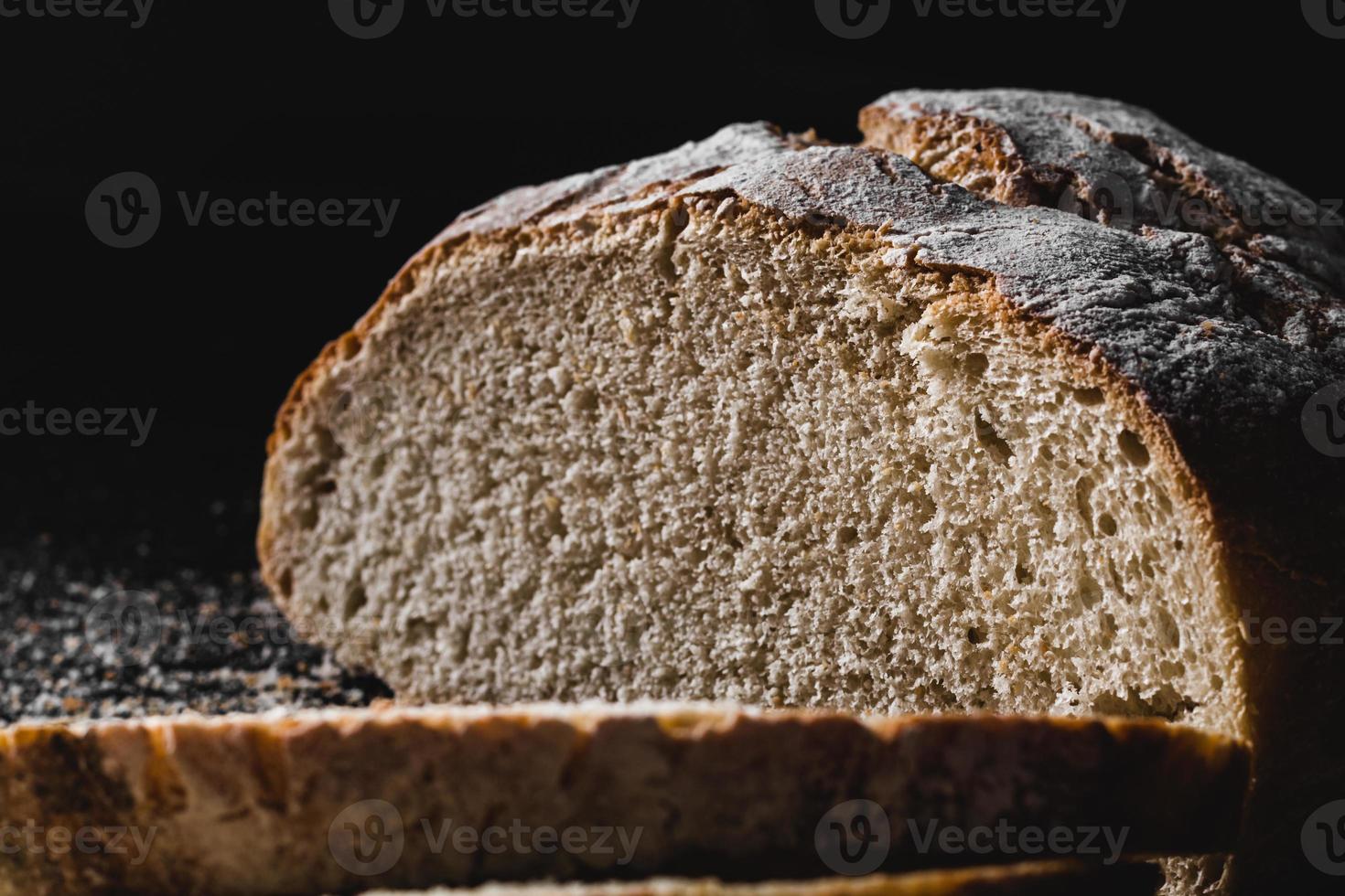 fette di pane casereccio scuro spolverato di farina foto