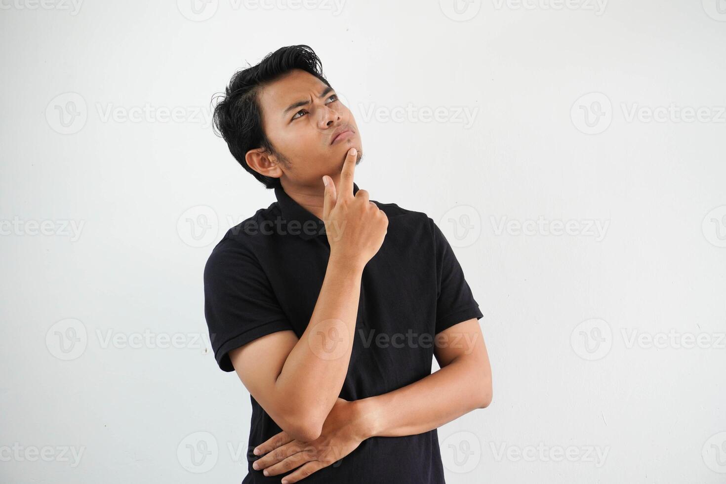 pensiero qualcosa idea giovane asiatico uomo e mano Tenere mento casuale attrezzatura nero polo t camicia isolato su bianca sfondo foto