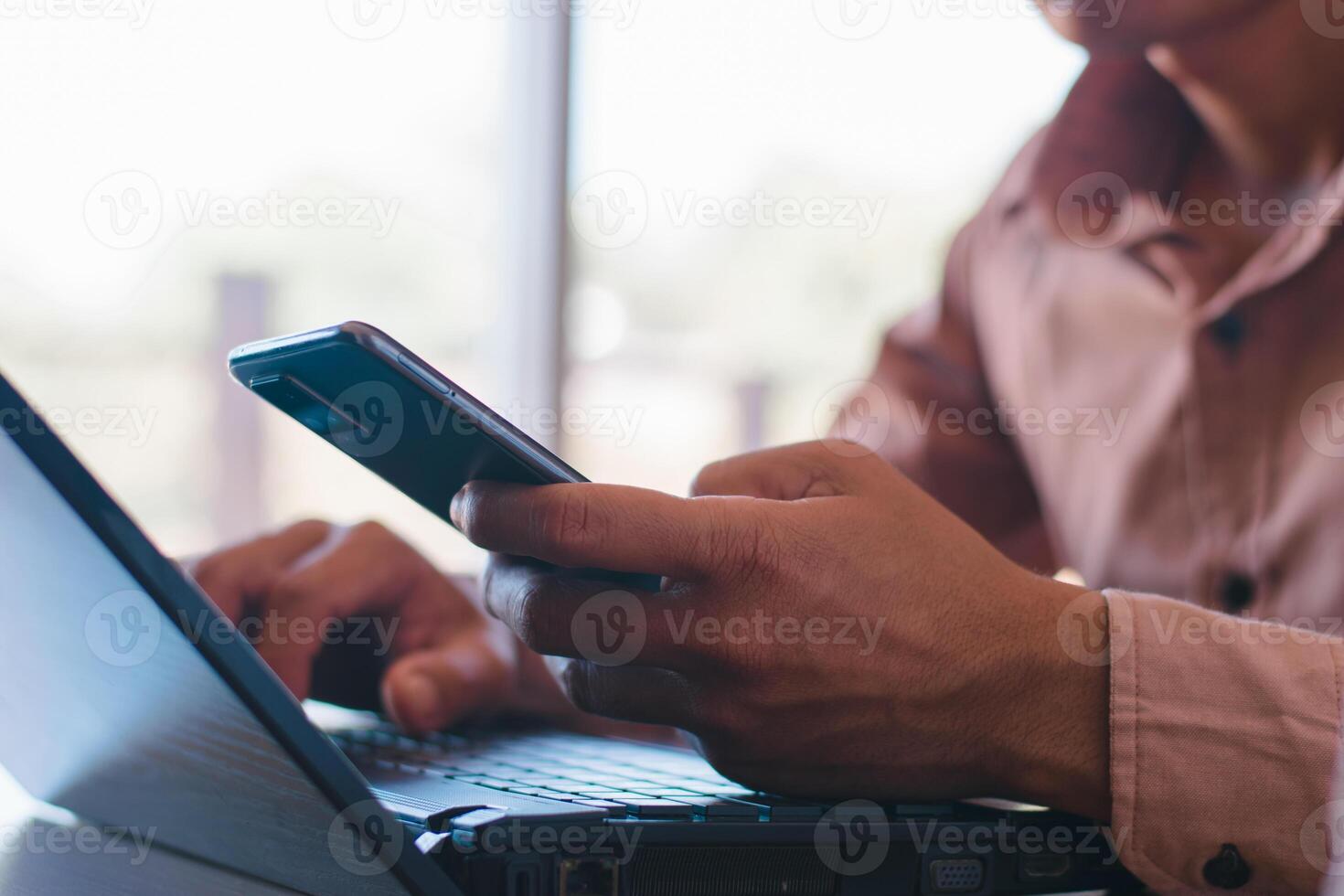 maschio mani Lavorando con taccuino computer e utilizzando mobile Telefono nel ufficio tavolo foto