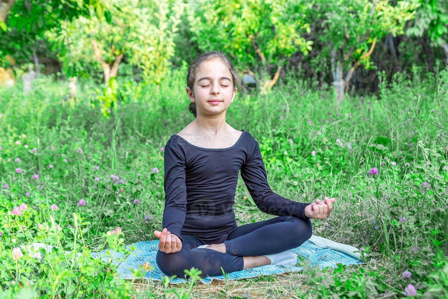 bella ragazza fare yoga esercizi, poco ragazza fare yoga esercizi nel il giardino foto