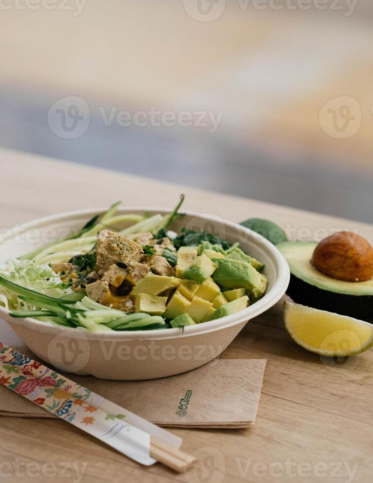 ciotola di avocado insalata con tofu e cetriolo su di legno tavolo foto