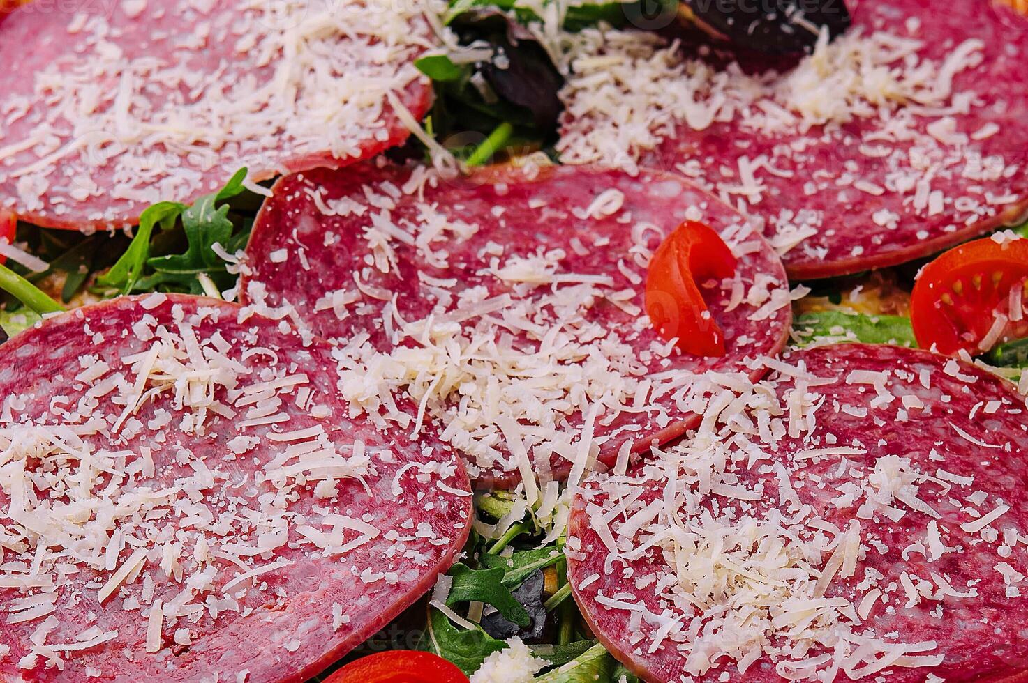 delizioso Pizza con salame, rucola e pomodori foto