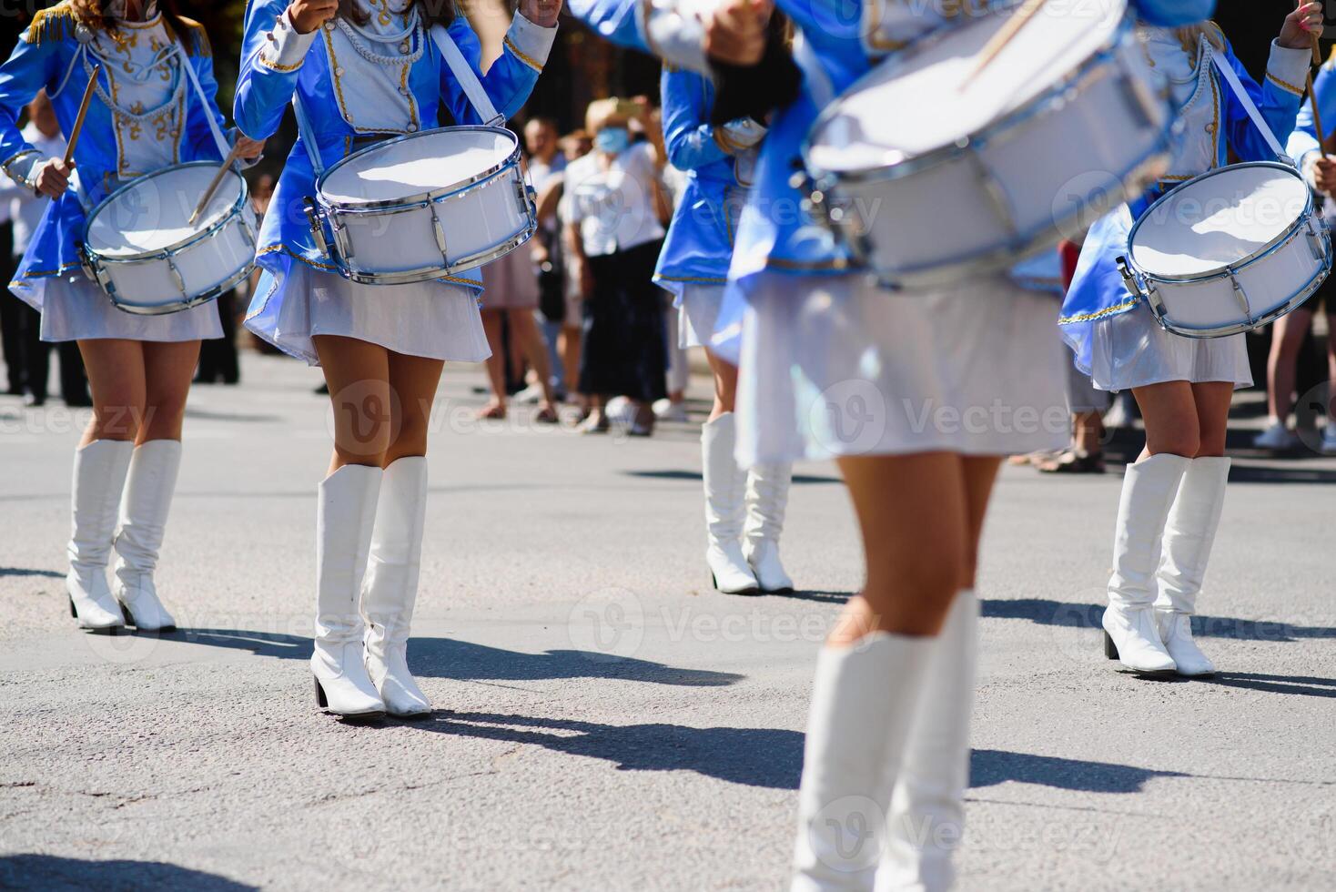 majorette con bianca e blu uniformi eseguire nel il strade di il città. fotografico serie foto