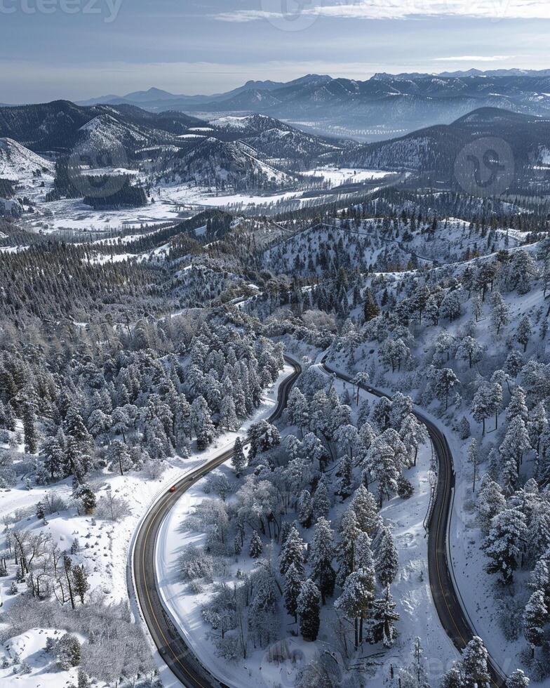 ai generato aereo Visualizza di avvolgimento strada nel montagne con neve foto