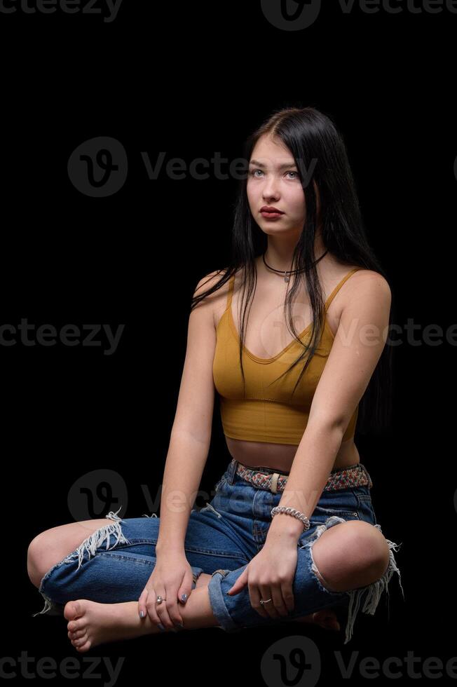 studio ritratto di un' giovane ragazza nel strappato jeans 3 foto