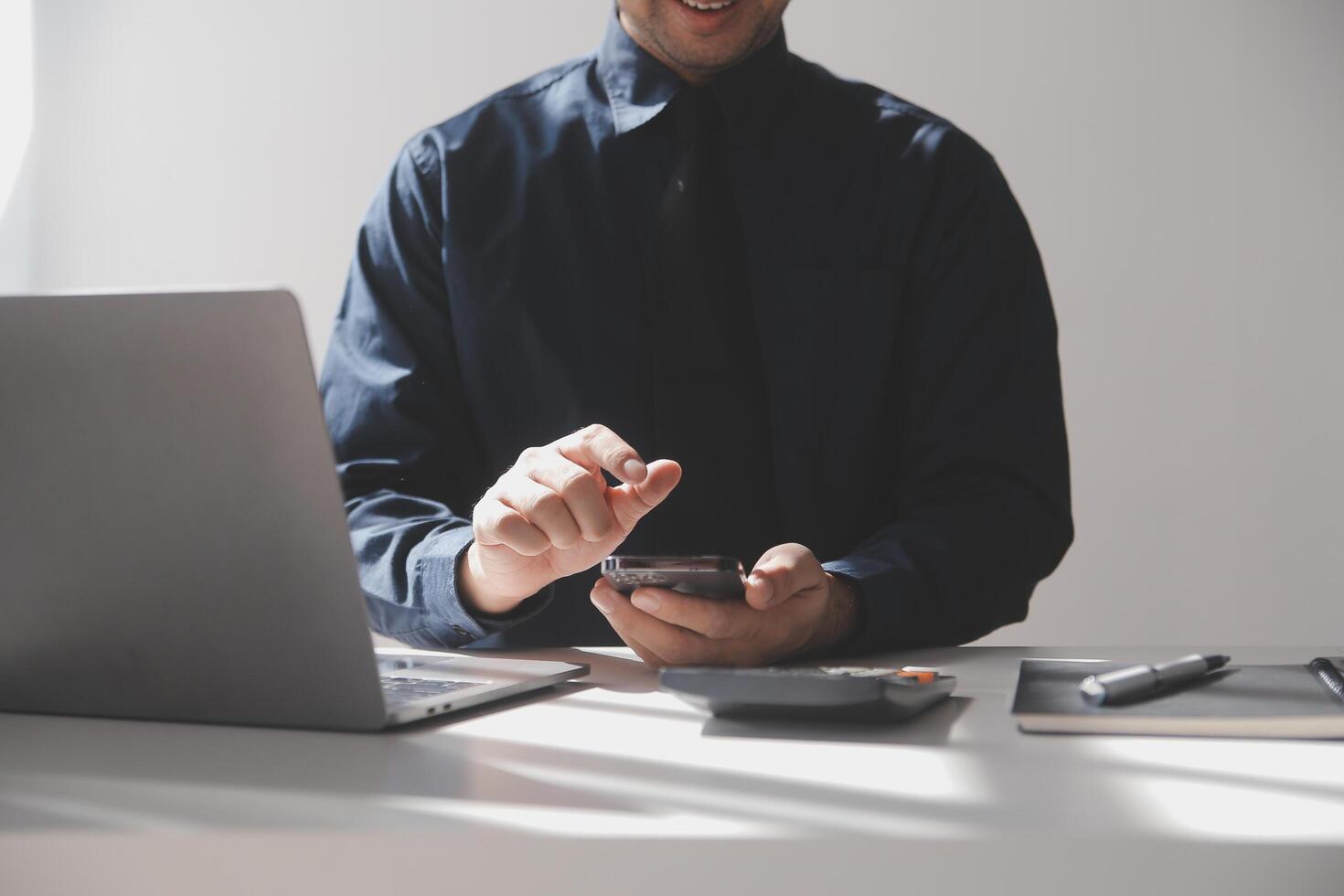 lato Visualizza tiro di un' dell'uomo mani utilizzando inteligente Telefono nel interno, posteriore Visualizza di attività commerciale uomo mani occupato utilizzando cellula Telefono a ufficio scrivania, giovane maschio alunno digitando su Telefono seduta a di legno tavolo, bagliore foto