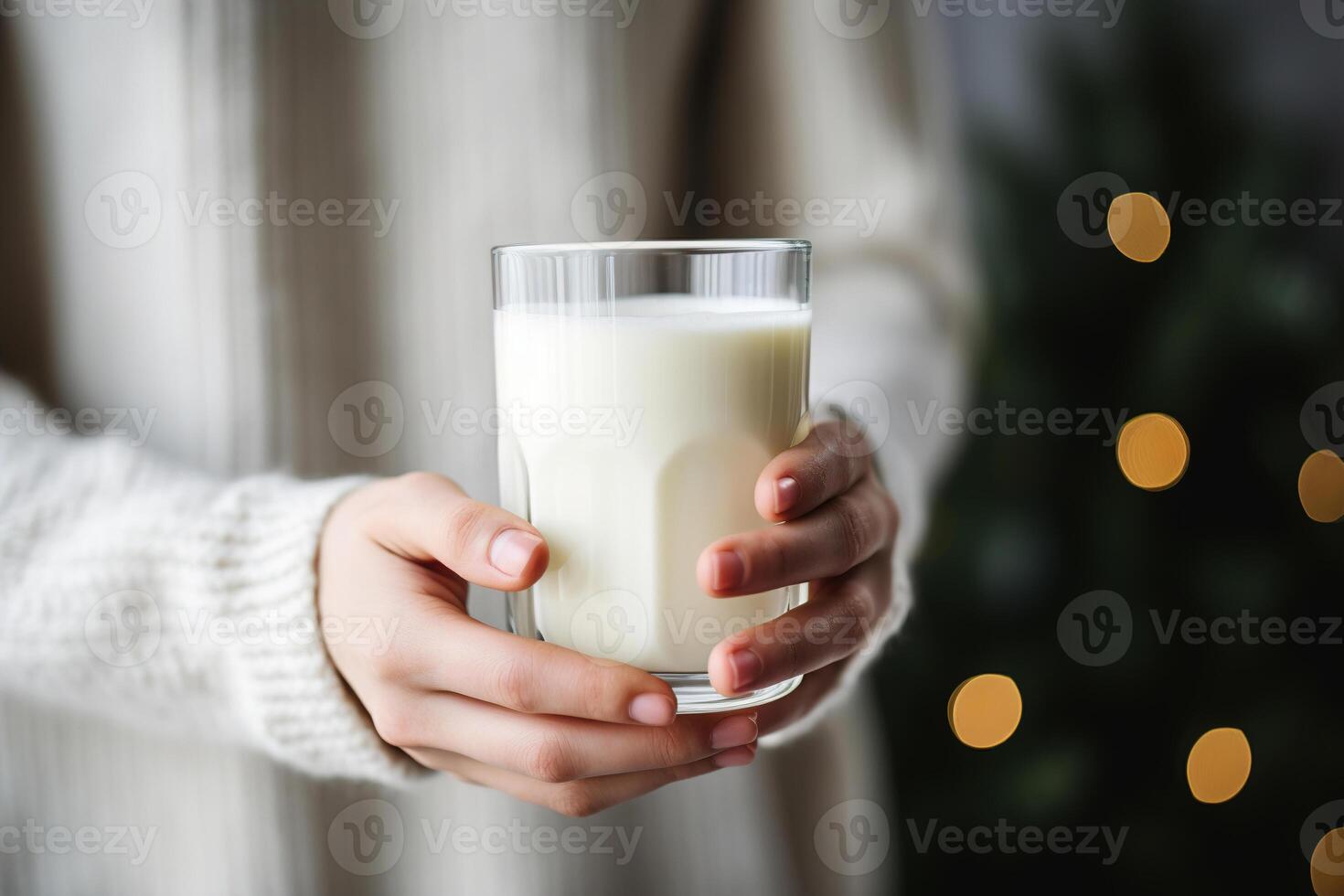 ai generato asciutto gennaio concetto. avvicinamento di femmina mani Tenere un' bicchiere di latte contro sfondo di un' Natale albero in casa foto