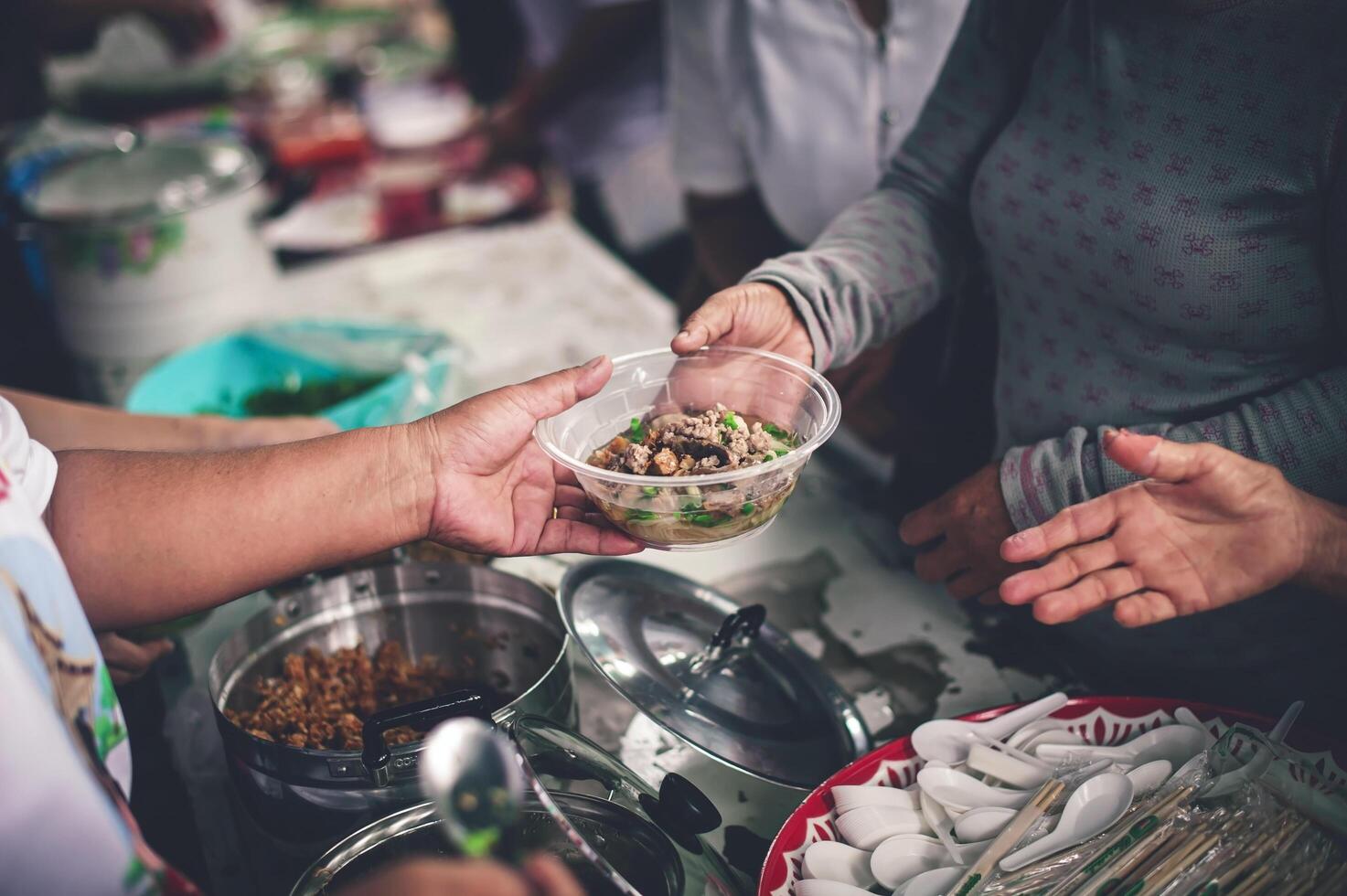 mani di povero persone chiede per cibo a partire dal volontari porzione concetto di cibo donazione foto