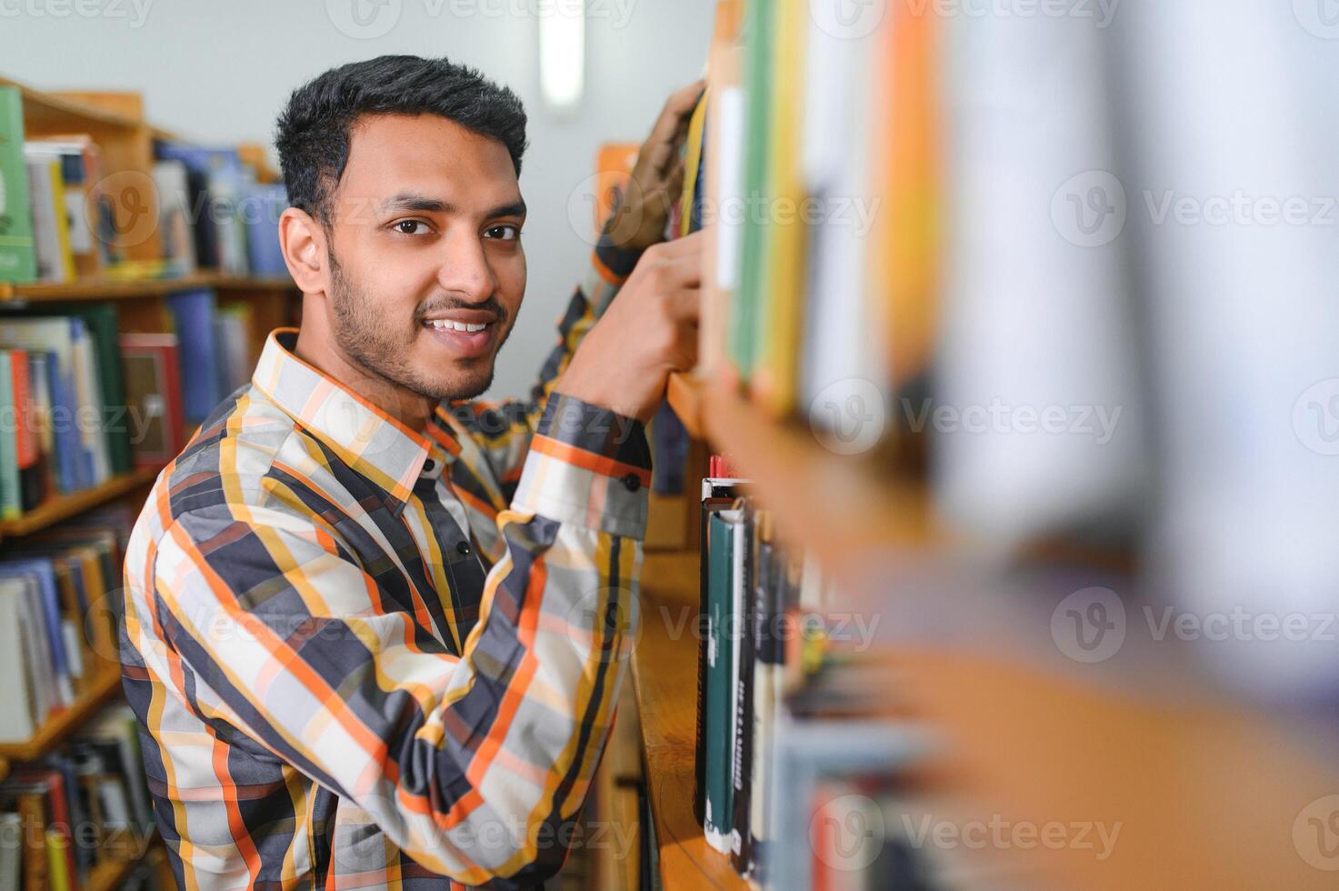 contento inteligente indiano o arabo tipo, misto gara maschio, Università alunno, nel il biblioteca foto