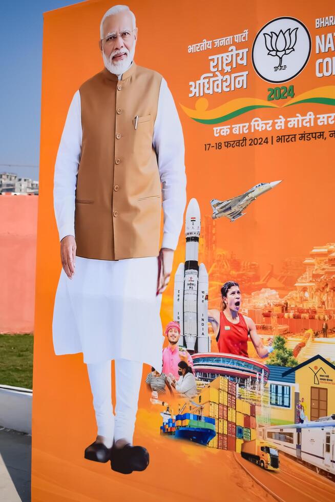 nuovo delhi, India - febbraio 17 2024 - primo ministro narendra modi tagliare su durante bjp strada mostrare, il manifesto di pm modi mentre frequentando un' grande elezione rally nel il capitale foto