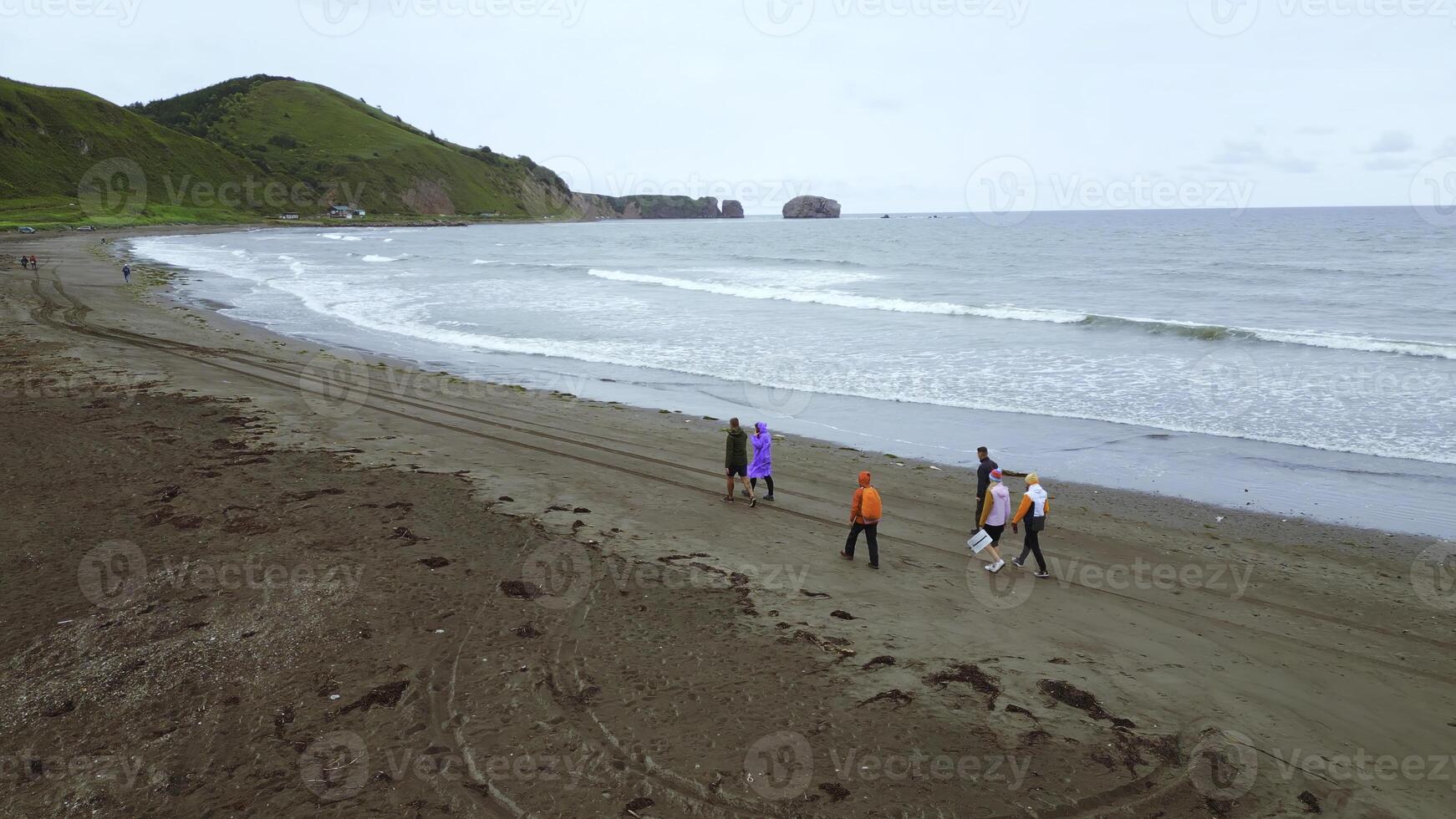 superiore Visualizza di persone di mare con montagna Visualizza. clip. costa con a piedi persone e sorprendente montagne su nuvoloso giorno. camminare su montagna costa di oceano su nuvoloso giorno foto